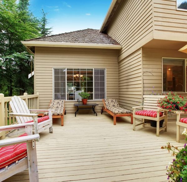 Pressure-treated wood deck with railing and outdoor seating area.