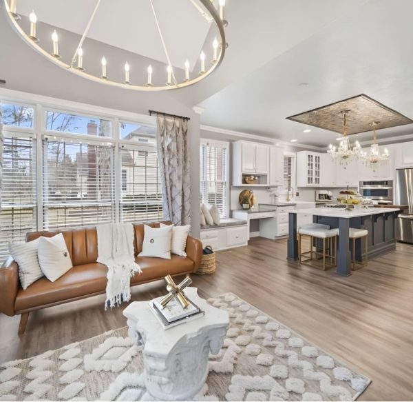 Open-concept kitchen and living remodel with wood flooring and modern finishes.